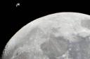 The International Space Station passes the moon