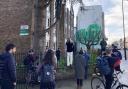 People gather in front of the potential Banksy earlier today (March 18)