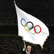 Wave of support: London Mayor Boris Johnson shows his sporting colours in Beijing