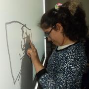 Manhoor, one of the artists, preparing her work for the exhibition
