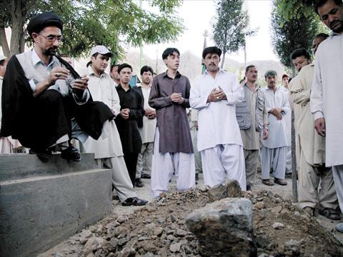 Burying three-time Olympic boxer Abrar Hussain who died after being shot in the head by unknown gunmen while driving home from his office, in June 2011.