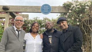 Roger Knight, Jacent Simmons, Eversley Mills and Nicky Miller beneath plaque to Metronomes co-founder Irvine Corridan