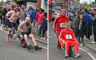 Revellers take part in a wheelbarrow race in Pinner for St George' Day
