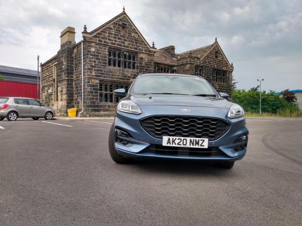 Times Series: The Ford Kuga Phev next to the restored Grade II-listed New Hall, Rooley Lane, Bradford