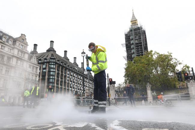 A street cleaner outside the Houses of Parliament