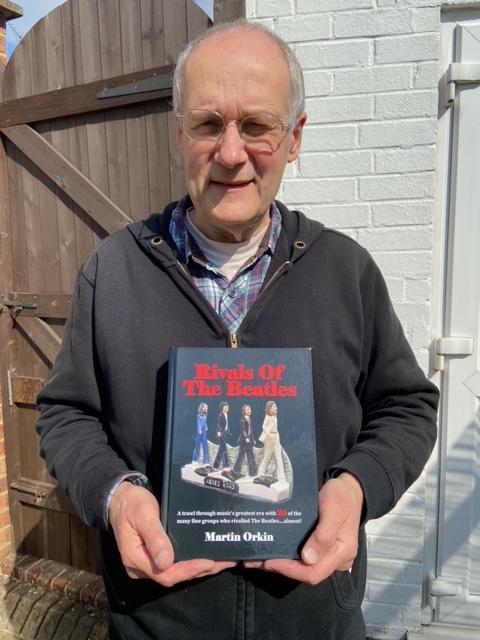 Times Series: Martin Orkin holding his book Rivals of the Beatles