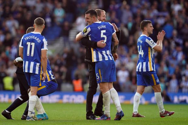 Brighton and Hove Albion manager Graham Potter celebrates with Lewis Dunk after the fans after the Premier League match at the AMEX Stadium, Brighton. Picture date: Saturday May 7, 2022.
