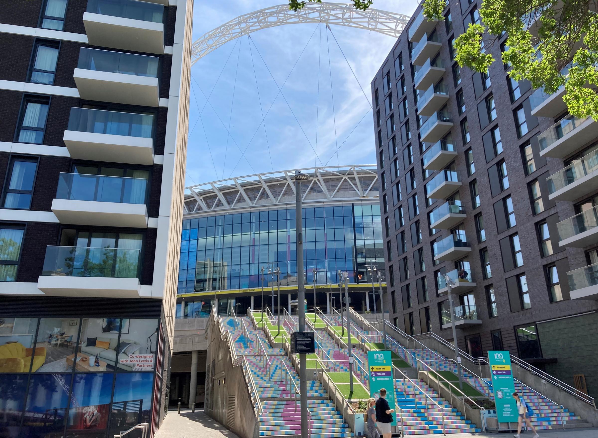 View Of The Stadium Behind The Flats. Brent Council launched its vision for Wembley in 2002 with he stadium at its heart. Image Credit: Grant Williams