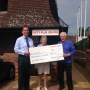 Store manager Paul Stephens presenting the cheque to volunteers Carol Stewart and Colin Ringham