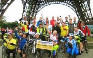 Wheelie excited: All 24 cyclists celebrate the completion of their four-day London to Paris adventure